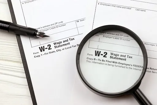 This image highlights a W-2 form, a crucial document for reporting employee wages and tax withholdings in the United States.