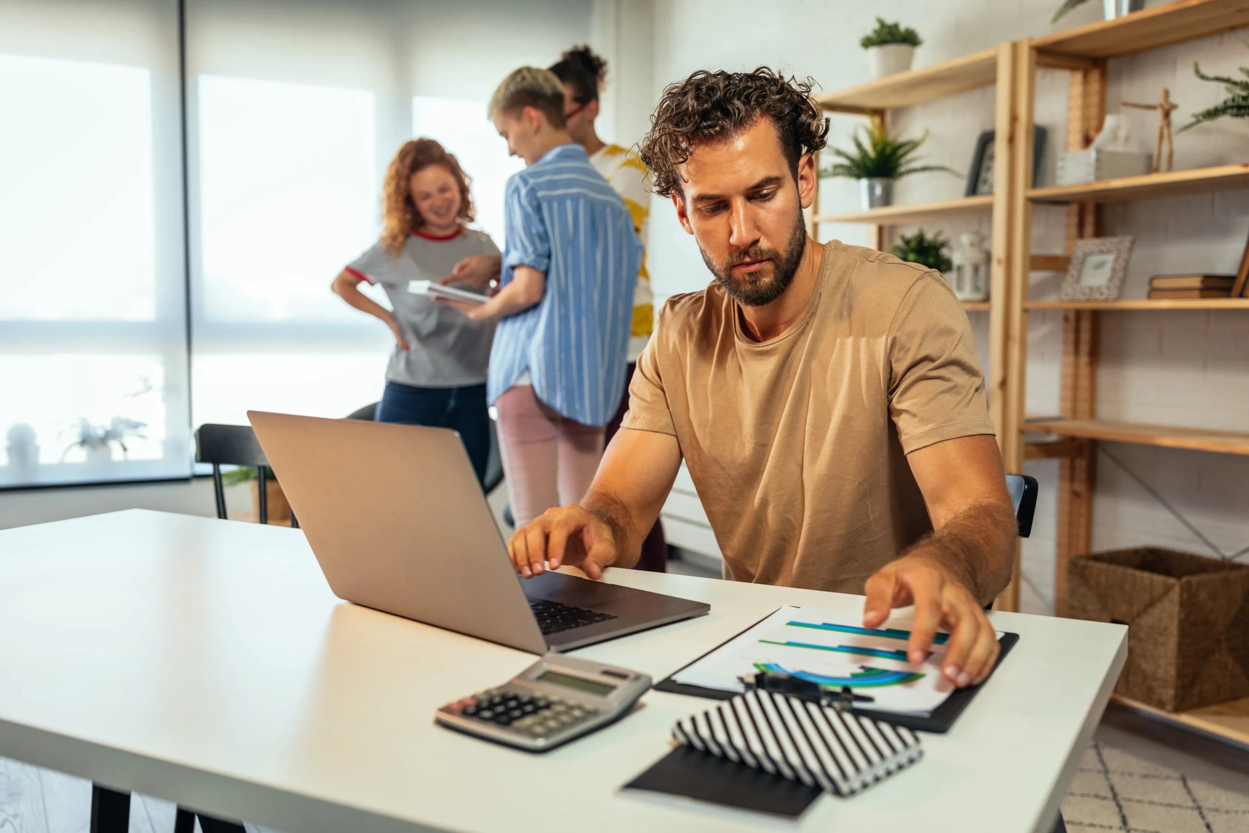 Simplifying Workforce Management With Payroll Services - A business man computing in front of his laptop working on payroll