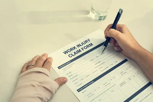 Person with a bandaged arm filling out a form.