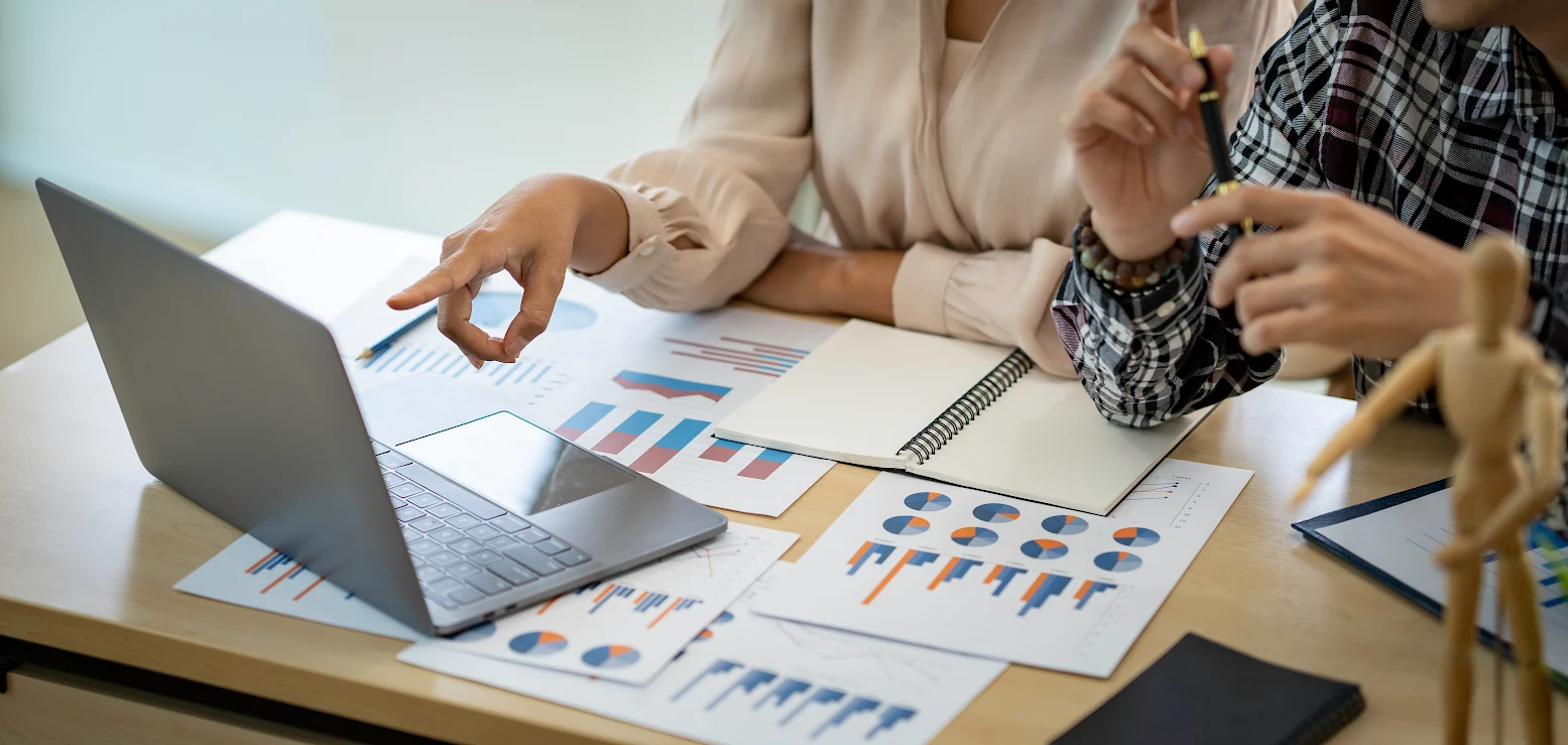 A team of resource professionals examine a series of charts and data.