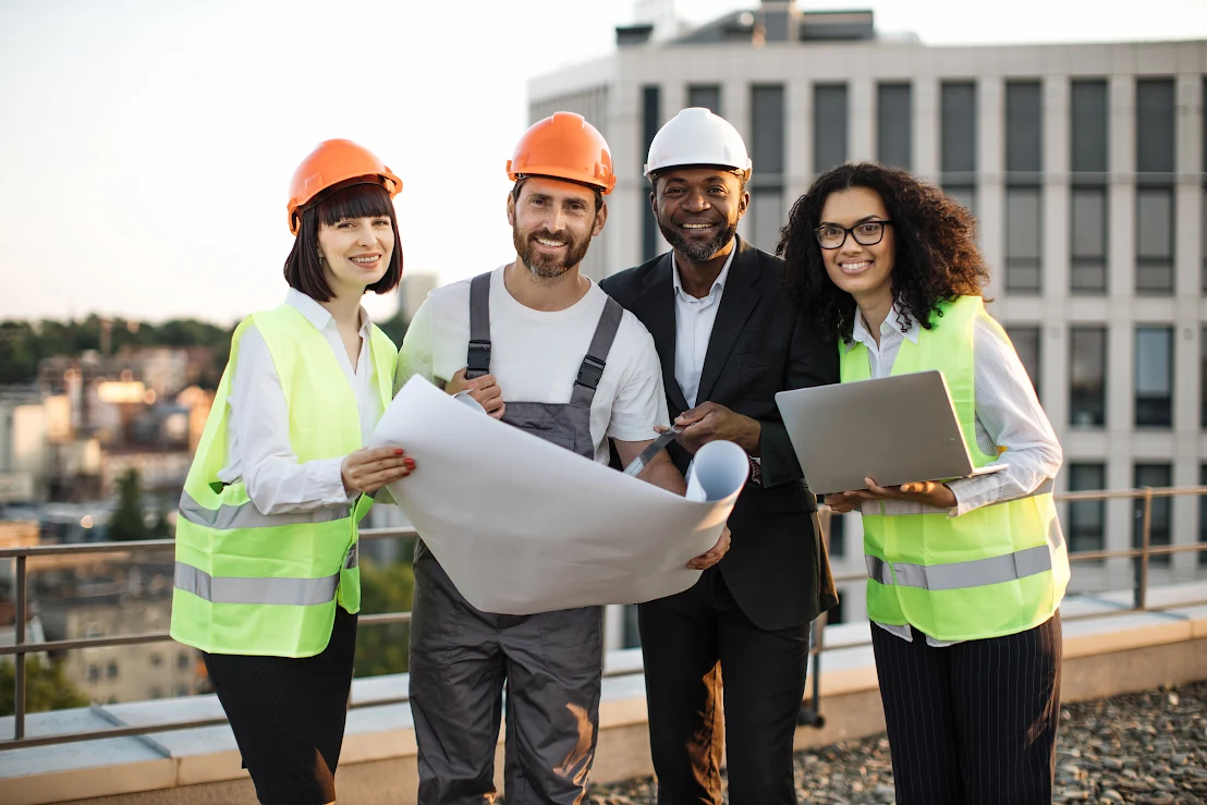 Construction professionals and independent contractors examine building plans.
