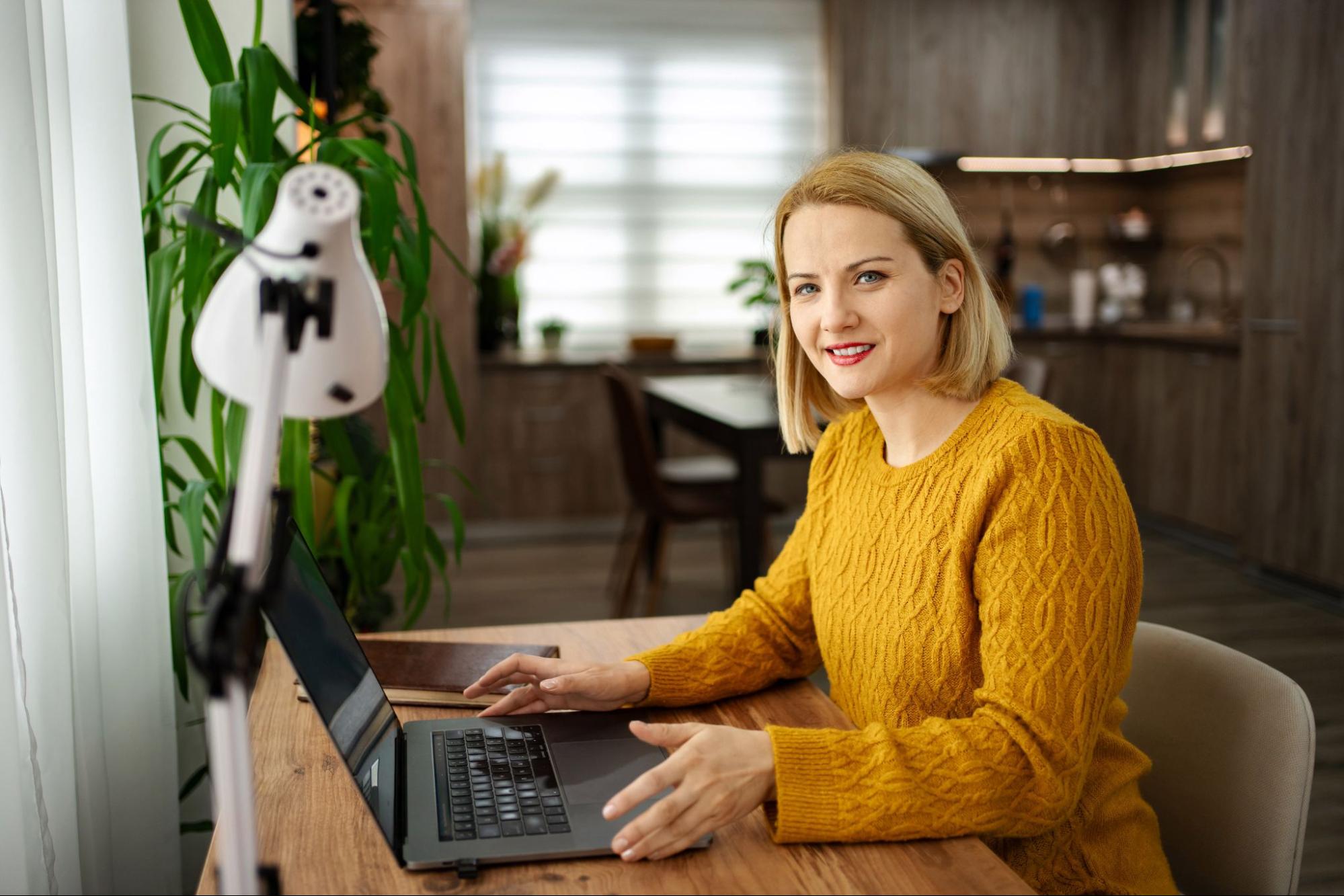 Independent creative woman enjoying remote work in her personalized home studio.