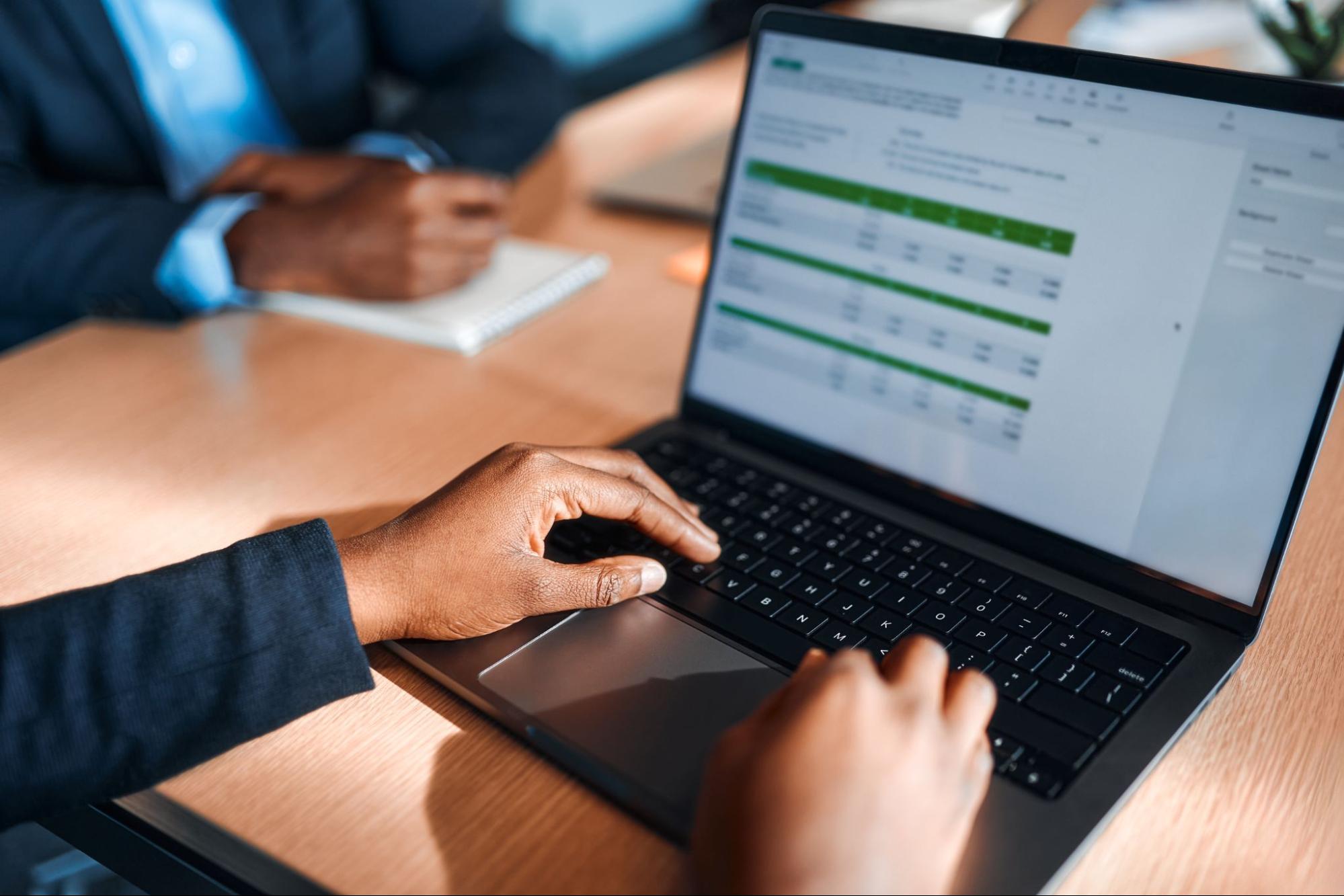 Cropped shot of a man processing payroll on his laptop.